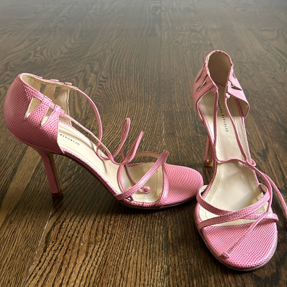 Pink leather lace up open toes.